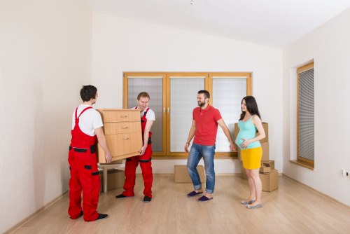 House movers loading furniture in Harrow residential street