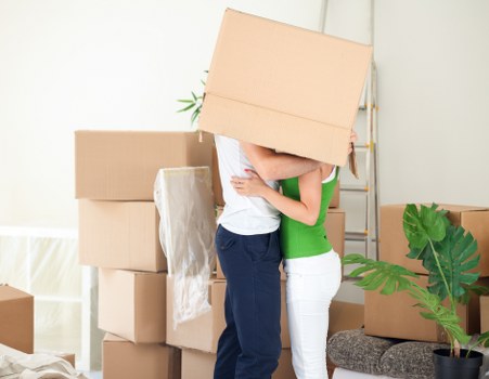 Loading furniture and boxes into a moving van in Harrow