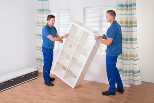 Removal helper loading furniture into a van for a Harrow house move