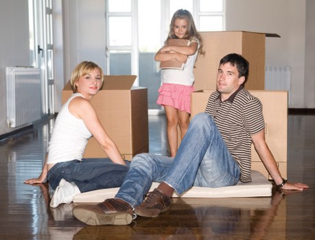 Movers carrying packed boxes from a flat in Harrow